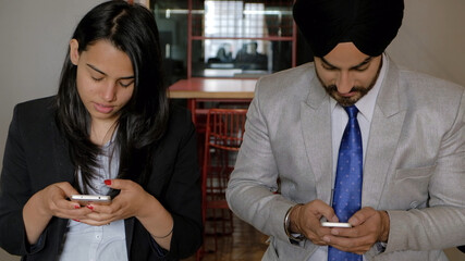 Poster - Group of Indian co-workers on their smartphones during the break