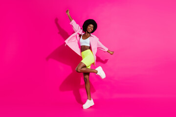 Wall Mural - Photo of shiny adorable dark skin lady wear casual shirt dancing smiling isolated pink color background