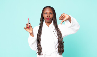 Wall Mural - black african american adult woman wearing bathrobe and holding a lipstick