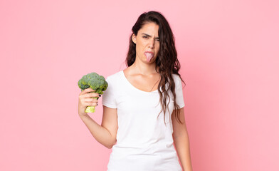 Wall Mural - pretty young woman holding a broccoli