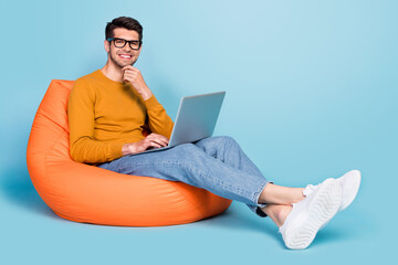 Wall Mural - Full body profile side photo of young man happy positive smile programmer use laptop isolated over blue color background