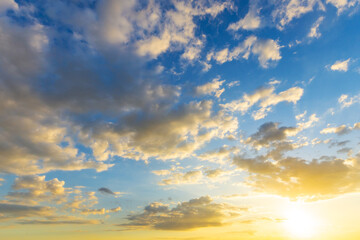 Wall Mural - Sky blue and orange light of the sun through the clouds in the sky