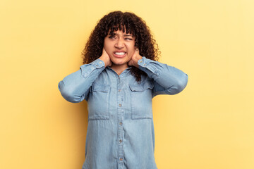 Poster - Young mixed race woman isolated on yellow background suffering neck pain due to sedentary lifestyle.