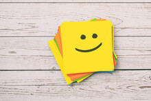 Happy Emoticon On Yellow Paper Note