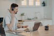 © VK Studio - Young guy adjusting headset while learning online at home