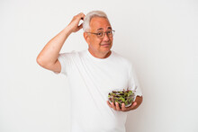 Senior American Man Eating Salad Isolated On White Background Being Shocked, She Has Remembered Important Meeting.
