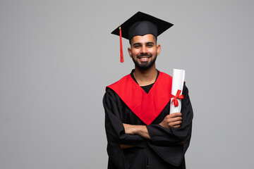Wall Mural - Young Graduation Man Holding Certificate Isolated On Grey Background
