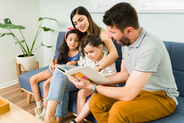 Wall Mural - Small kids learning how to read with mom and dad