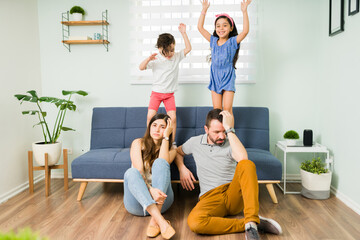 Wall Mural - Portrait of an exhausted mom and dad at home