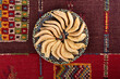Traditional Moroccan handmade cookies in a ceramic plate on a colorful carpet.