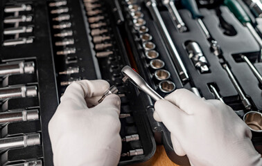 Wall Mural - Car repair tools in male hands close up