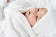 © geargodz - close up baby in soft bathrobe on bed