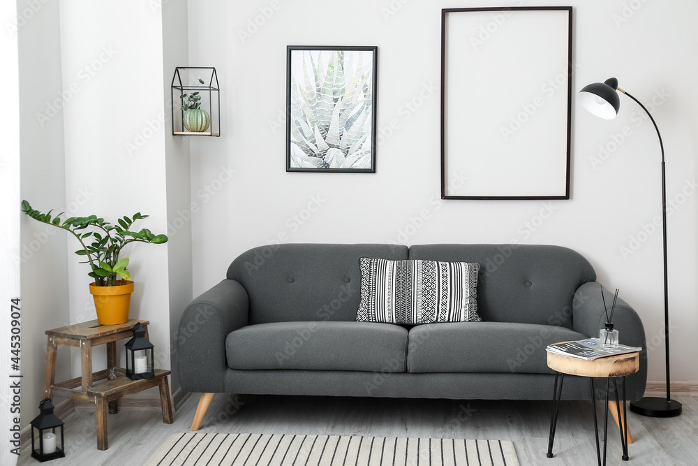 Interior of stylish living room with comfortable sofa - obrazy, fototapety, plakaty 