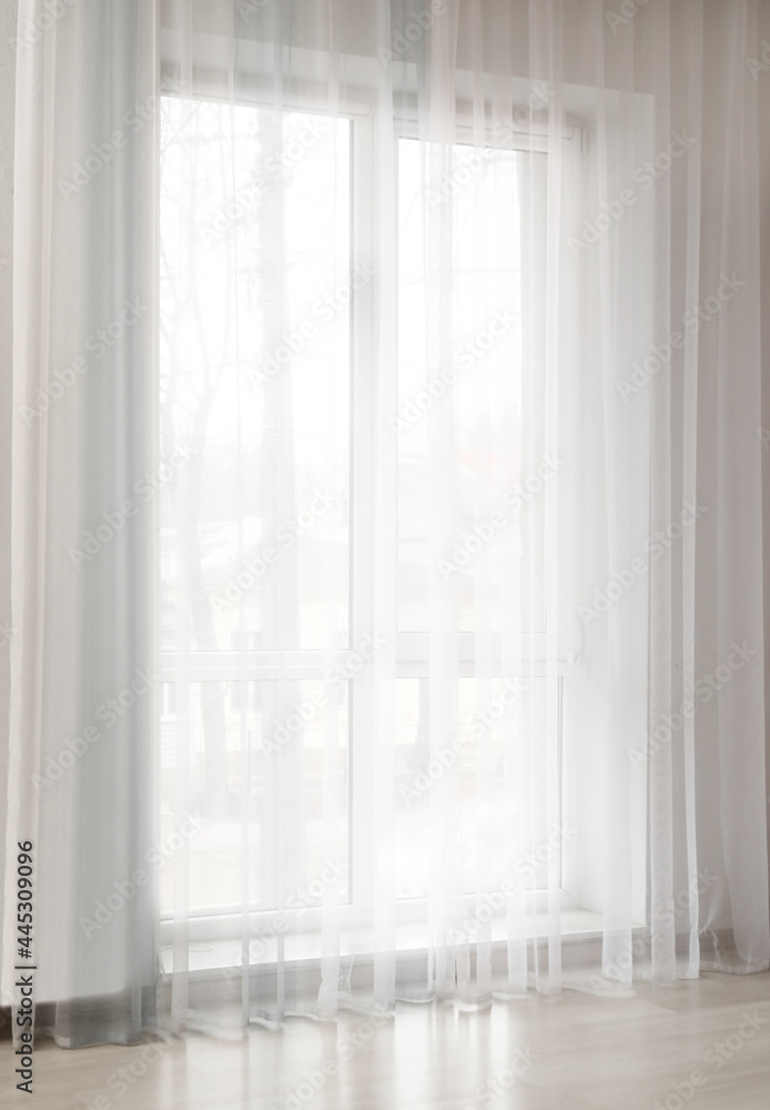 Light curtains on window in room