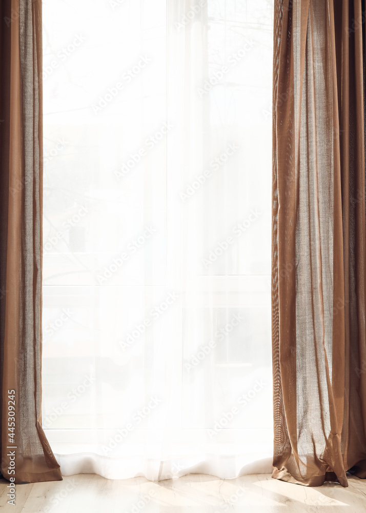 Light curtains on window in room