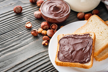 Wall Mural - toasts with chocolate butter on a dark wooden rustic background