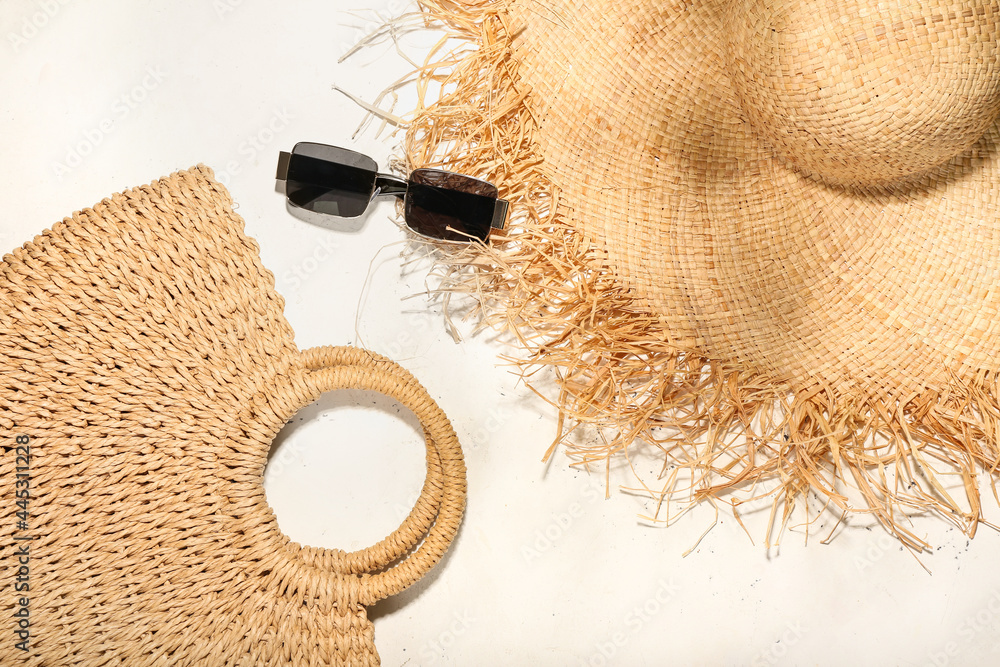 Stylish hat, bag and sunglasses on light background - obrazy, fototapety, plakaty 