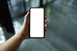© Charlie's - Women's hands holding cell telephone blank copy space screen. smart phone with technology concept