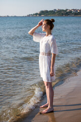 young woman admires the beauty of the sea