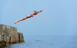 Teen girl 9 years jumping into sea from breakwater