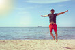 Man jumping on the beach happy