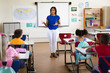 © WavebreakMediaMicro - African american female teacher teaching students in the class at elementary school