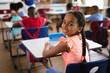 © WavebreakMediaMicro - Portrait of african american girl smiling while sitting in the class at elementary school