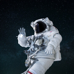 Wall Mural - space man in a suit with a helmet waves his hand and greeting in open space. hello concept. astronau