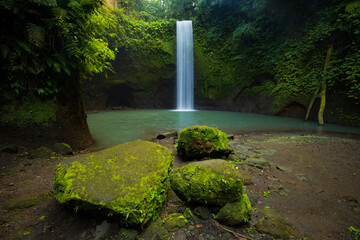 Wall Mural - Waterfall landscape. Beautiful hidden waterfall in tropical rainforest. Nature background. Slow shutter speed, motion photography. Tibumana waterfall, Bali, Indonesia