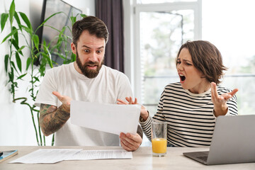 Young white couple working together with laptop