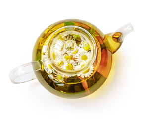 Glass teapot with tea, mint leaves and chamomile isolated. Top view flat lay. Chamomile teapot. Hot drink.