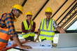 © visoot - Engineers or architect holding a pen with drawings in construction on blueprints in construction site for discussing,Engineering tools and construction concept.