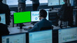 © Gorodenkoff - Green Screen Horizontal Mock Up on a Computer Display Used by a Male Trade Specialist. Team of  Brokers and Finance Specialists  Sit in Front of Computers and Work with Big Data.