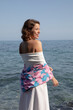 © Dellealpi - Natural beauty of as young lady Posing in the shore of the coast side in a tourist location. looking the sea