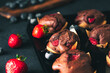 Muffin. Chocolate muffins with stawberry. Muffins on wooden stand.