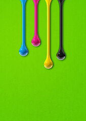 Wall Mural - cmyk ink drops on green paper background