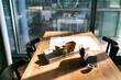 © Florian K√ºttler/Westend61 - Sunlight falling on blueprint and architectural model at office