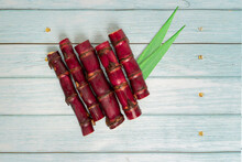Red Cane Sugar With Leaf On Blue Wooden Background