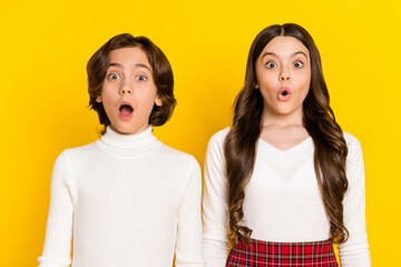 Poster - Photo portrait of children amazed staring with opened mouth isolated on vivid yellow color background