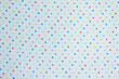 © Elena Fetisova - White fabric with multicolored small polka dots.Fabric background and texture for design