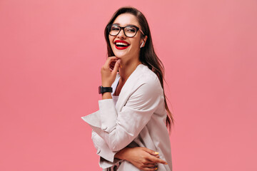 Lady in great mood laughing on pink background. Cute long-haired woman with beautiful smile in black watch looks at camera..