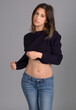 Standing Woman in Cropped Blue Sweater and Jeans