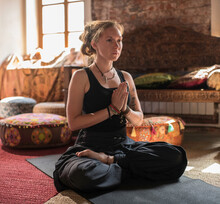 Woman Meditating In Lotus Pose