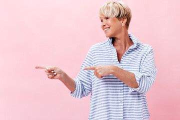 Wall Mural - Adult woman in plaid shirt pointing to place for text