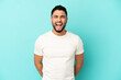© luismolinero - Young arab man isolated on blue background shouting to the front with mouth wide open