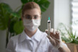 © jutaphoto - Doctor or scientist in lab hospital with injection syringe in hand. Close up, selective focus