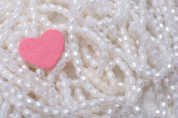 Sticker - Closeup shot of pink heart pearls on white background