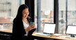 © Natee Meepian - beautiful freelancer working on laptop with coffee cup in home office. portrait asian woman working.