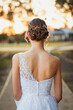 Girl in debutante outfit from behind in beautiful afternoon sun, no face visible