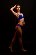 © Ivan Zelenin - Slim tanned woman body over gray background